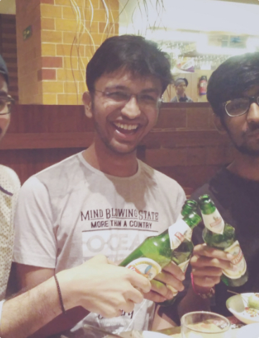 Priyank clinking a pint with his friends